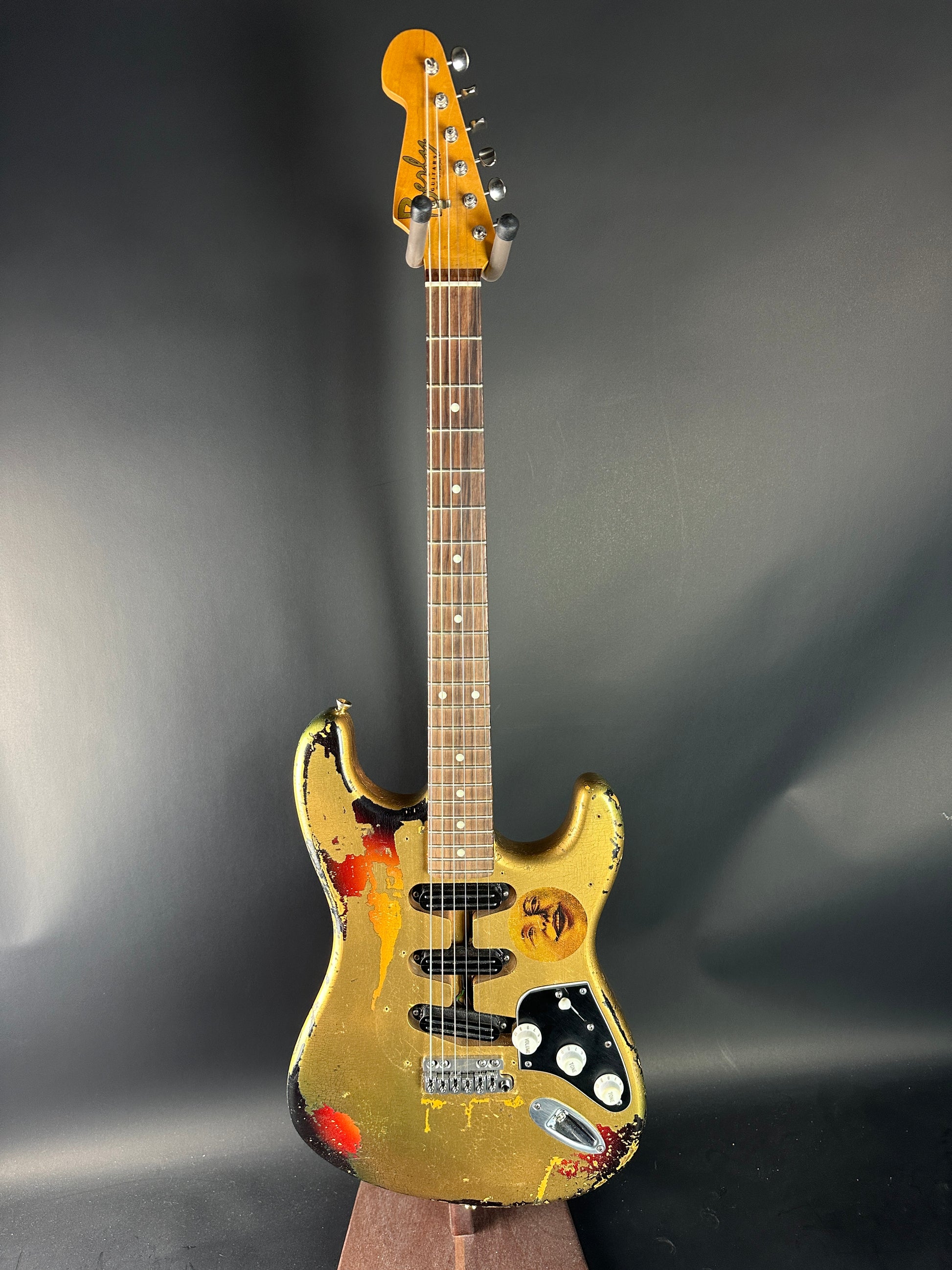 Gold electric guitar on a dark gray background