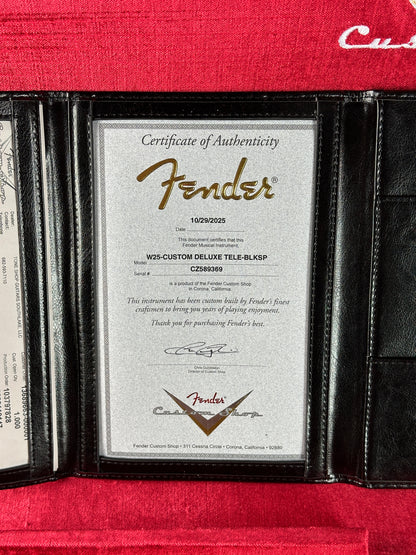 Fender certificate of authenticity inside a black leather wallet on a red background