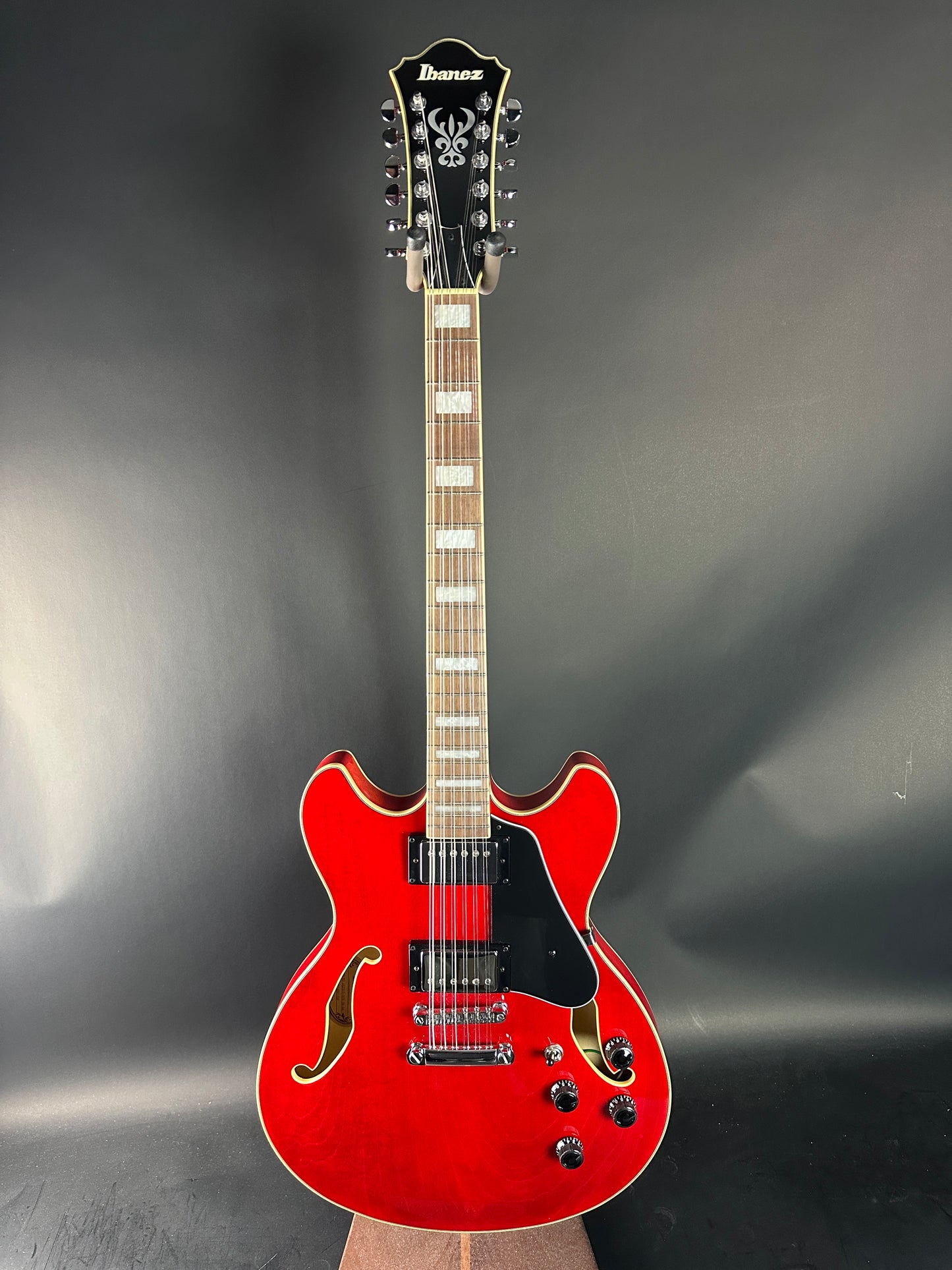 Red electric guitar on a gray background