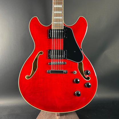 Red electric guitar on a gray background