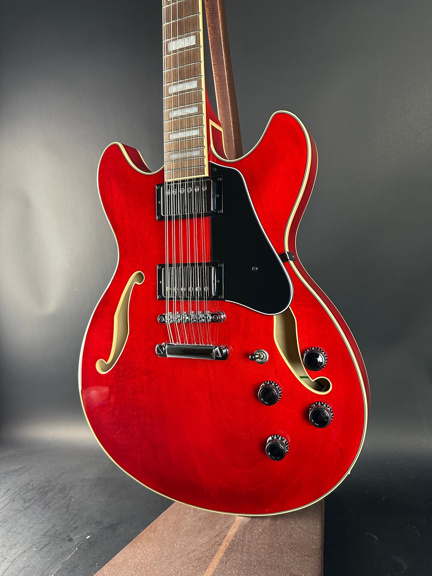 Red electric guitar on a dark background