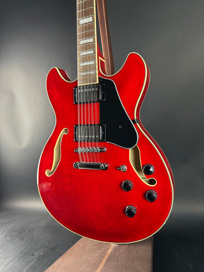 Red electric guitar on a dark background