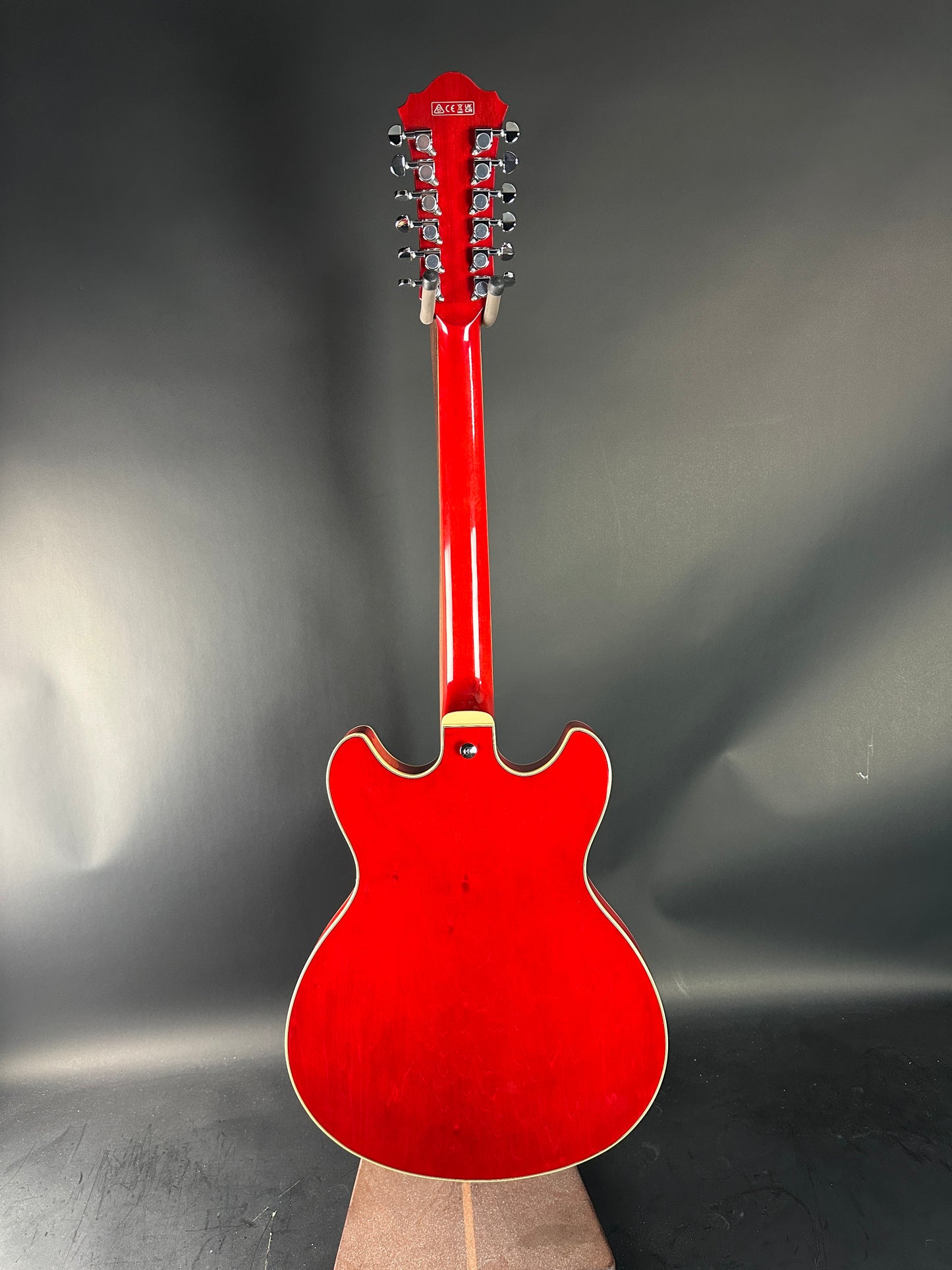 Red twelve-string guitar on a gray background