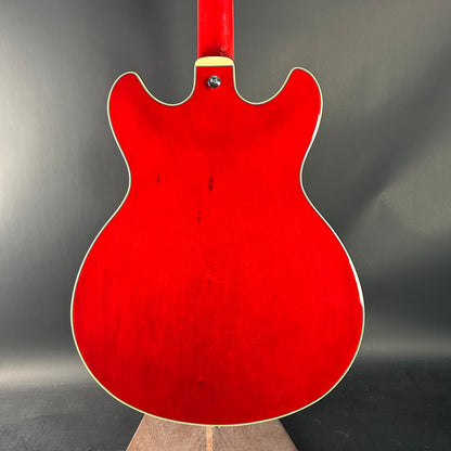 Red electric guitar on a gray background