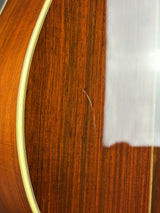 Close-up of a polished wooden surface with a warm brown wood grain and a light gold bevel edge.