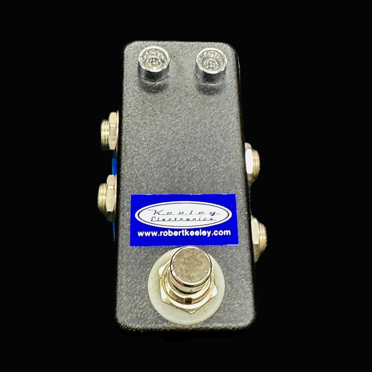 Guitar pedal with a brand label on a gray background