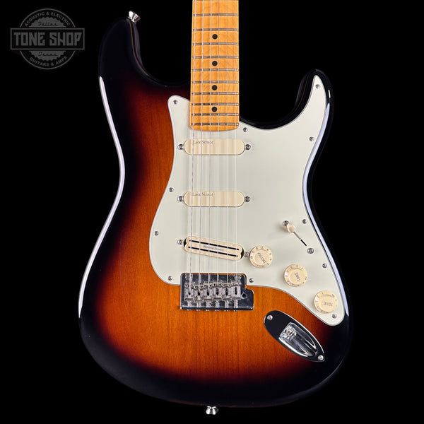 Electric guitar with a sunburst finish on a black background, featuring the Tone Shop logo.