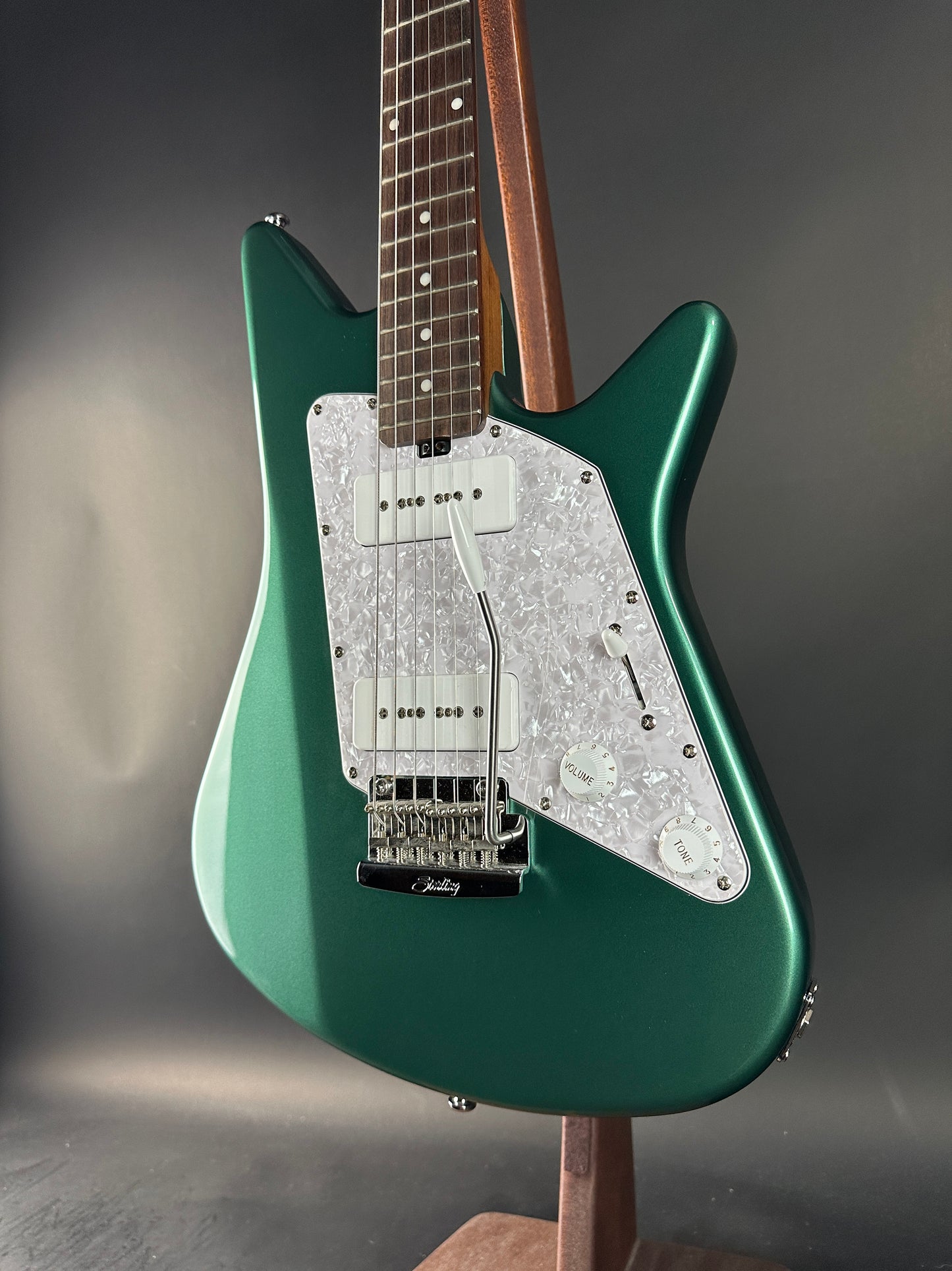 Green electric guitar on a gray background