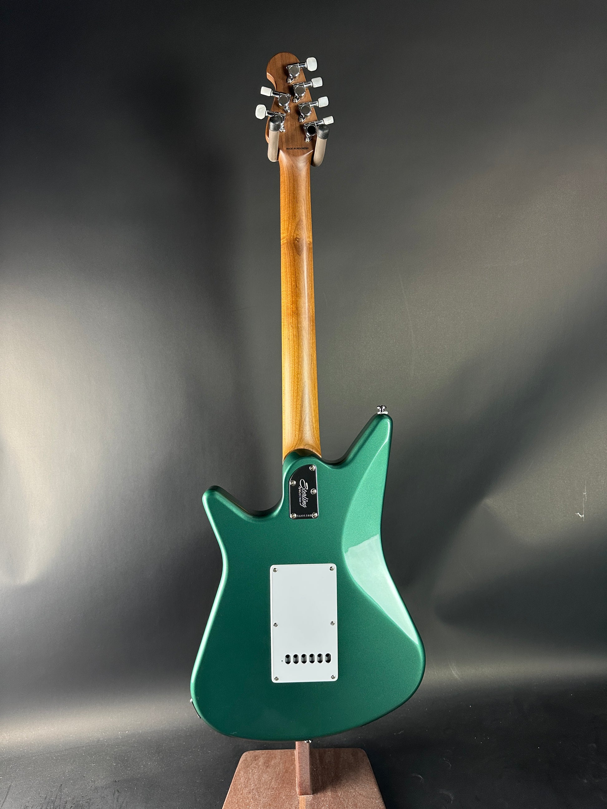 Green electric guitar on a gray background