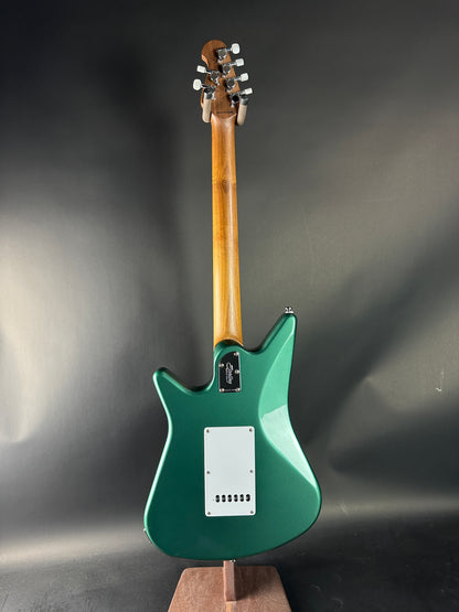 Green electric guitar on a gray background