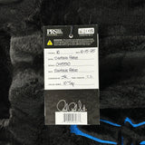Close-up of a guitar string label with product details on a textured black background