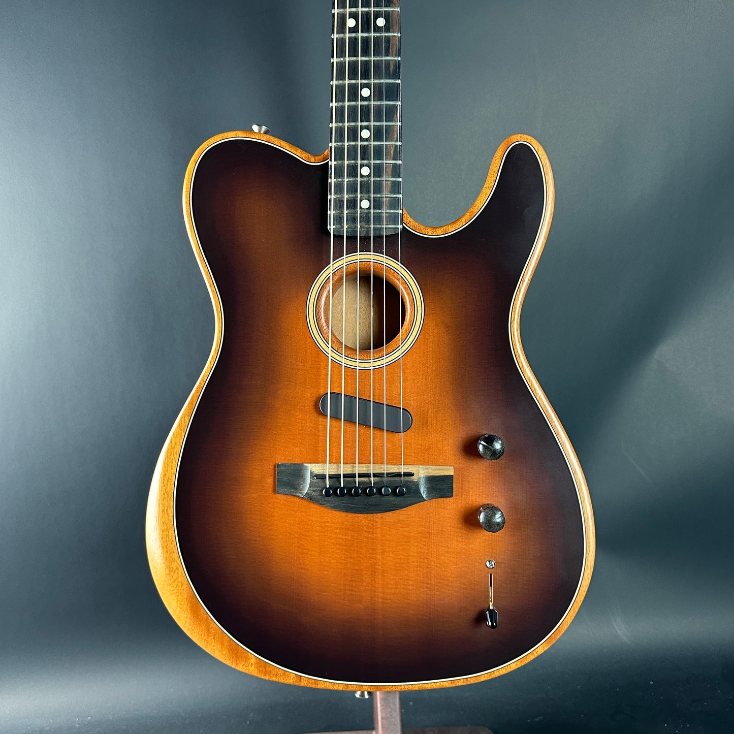 Acoustic guitar with a sunburst finish on a dark gray background
