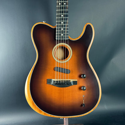 Acoustic guitar with a sunburst finish on a dark gray background
