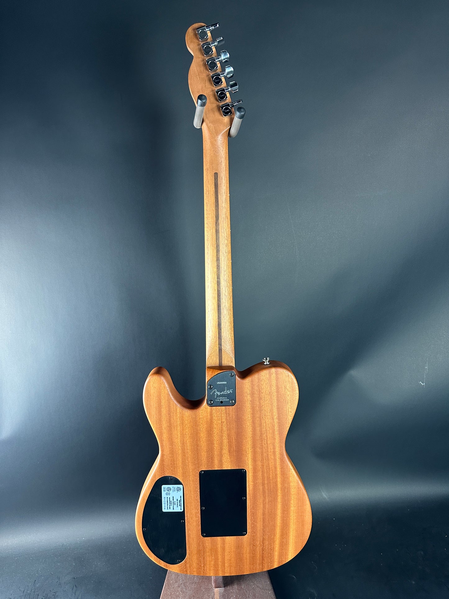 Wooden electric guitar on a dark gray background