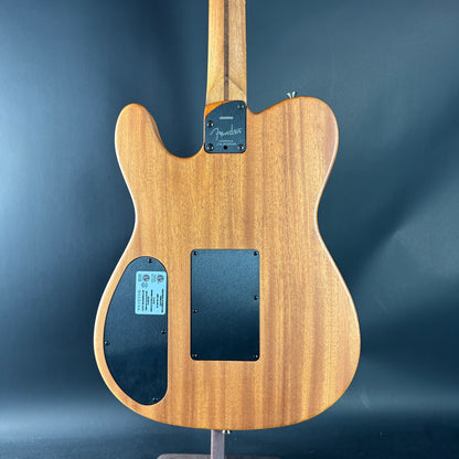 Back view of a Fender electric guitar on a dark blue background