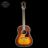 A vintage-style acoustic guitar with a sunburst finish, shown vertically against a solid black background. The brand 'Tone Shop' is visible as a watermark in the top-left corner.