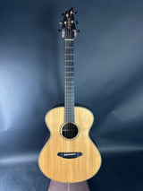 Acoustic guitar on a reflective dark blue surface