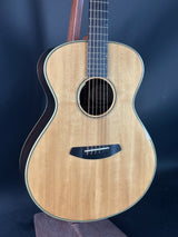 Acoustic guitar with a wooden finish on a dark blue background