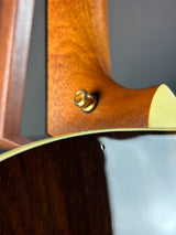 Close-up of a guitar's wooden neck and headstock