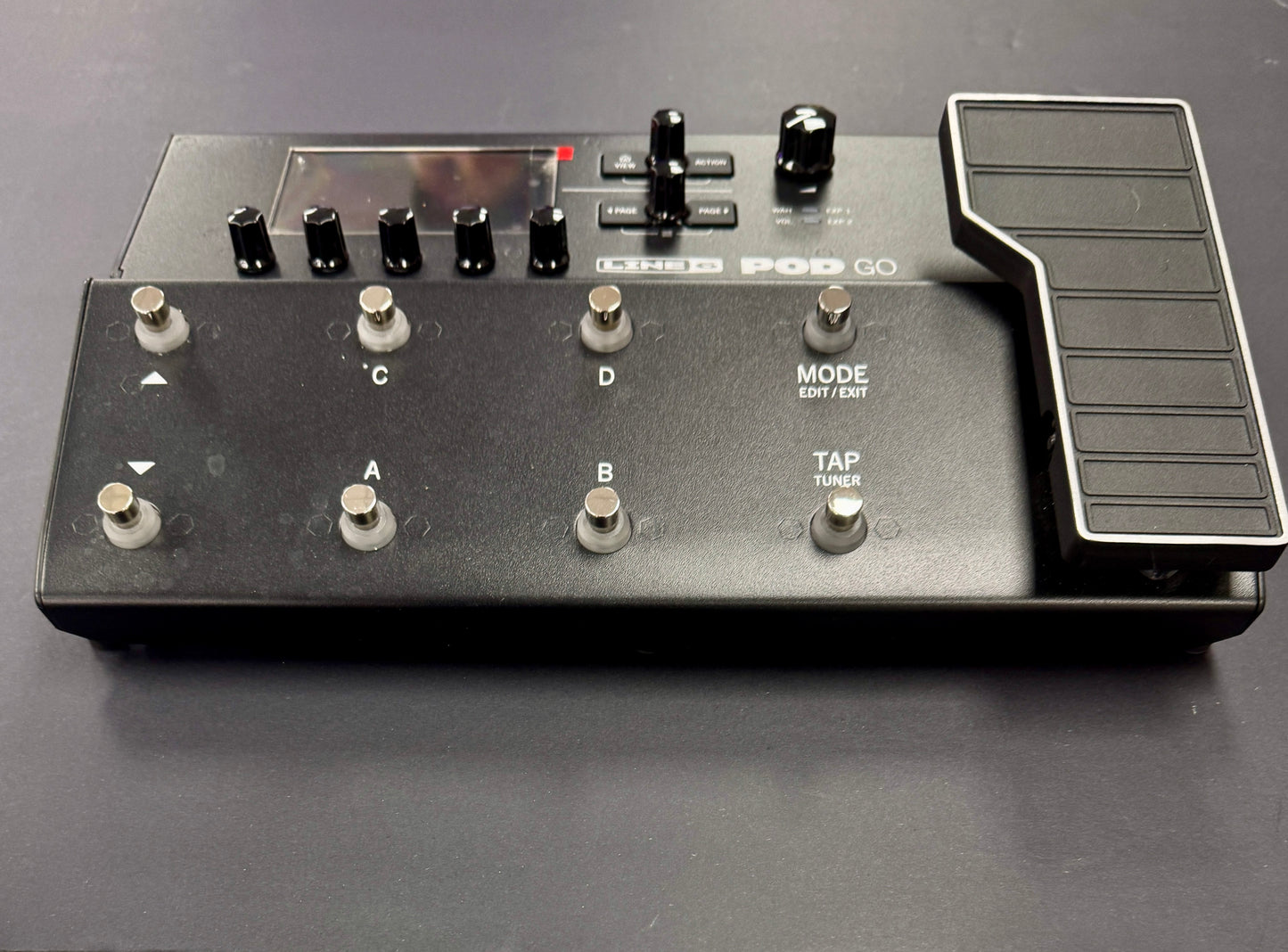 Black electronic device with buttons and controls on a gray background