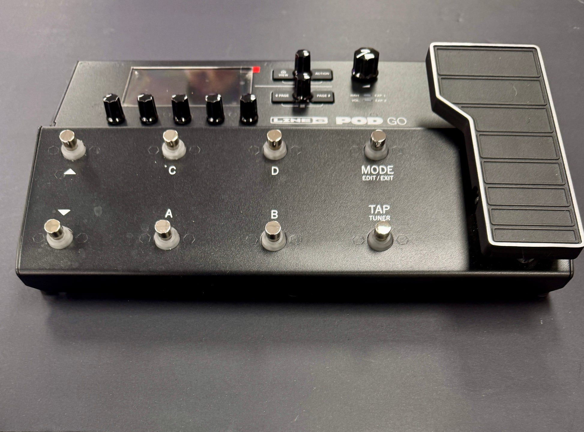 Black electronic device with buttons and controls on a gray background