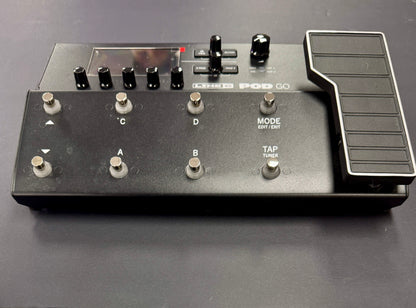 Black electronic device with buttons and controls on a gray background