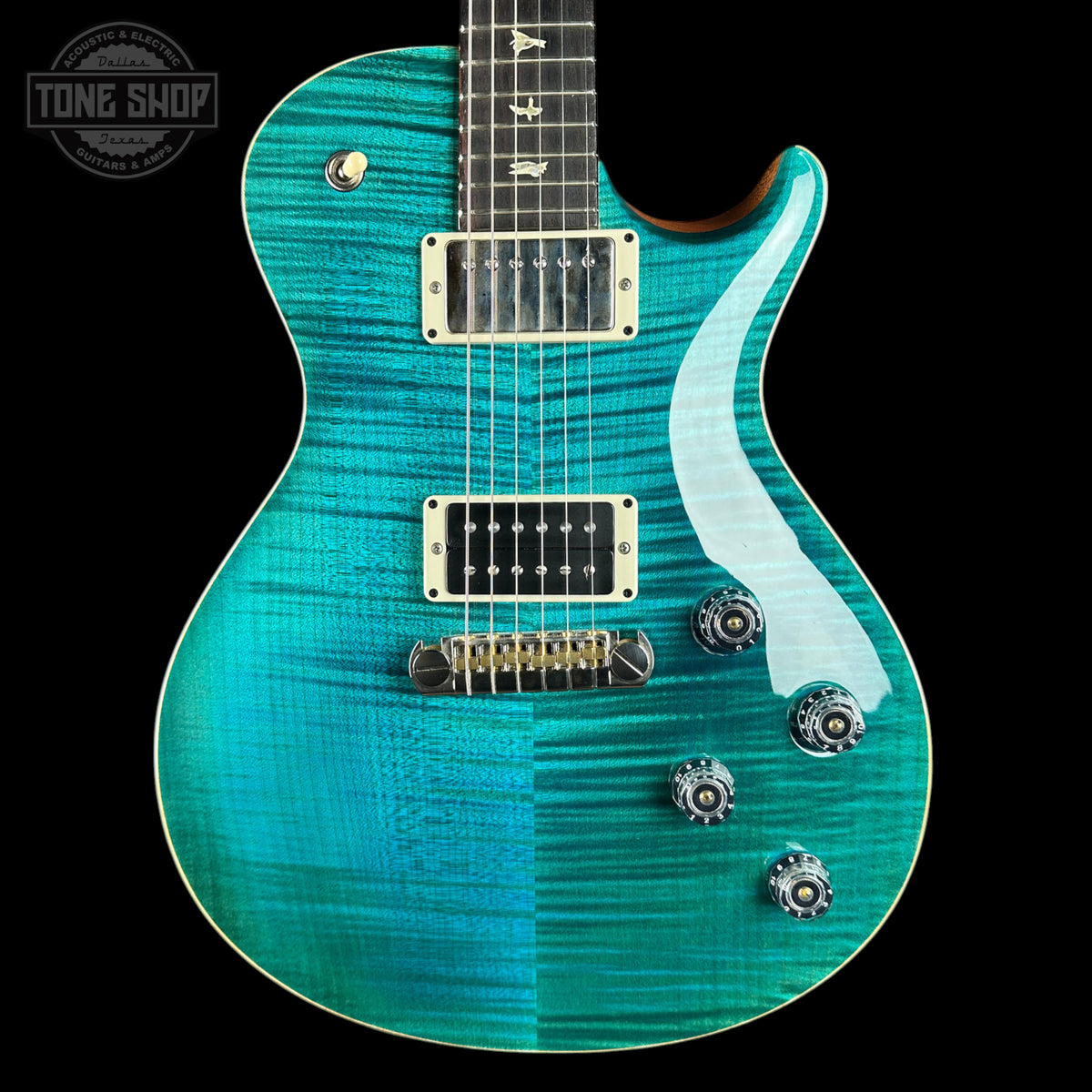 A turquoise blue electric guitar with a flamed maple top, featuring a white pickguard, gold hardware, and a black neck, shown against a solid black background.