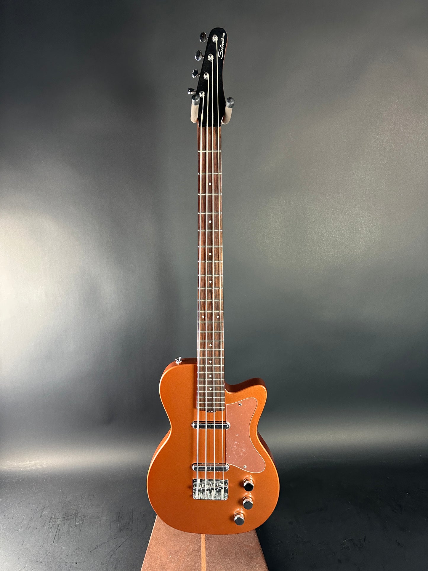 Electric guitar with a sunburst finish on a dark gray background