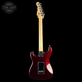 A red electric guitar shown from the back against a solid black background, featuring a maple neck and a Tone Shop logo watermark in the top left corner.