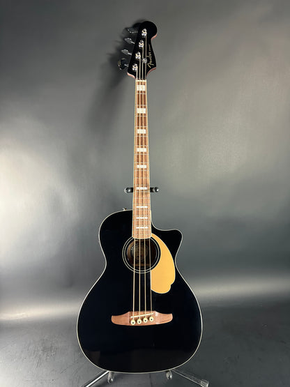 Black acoustic guitar on a gray background