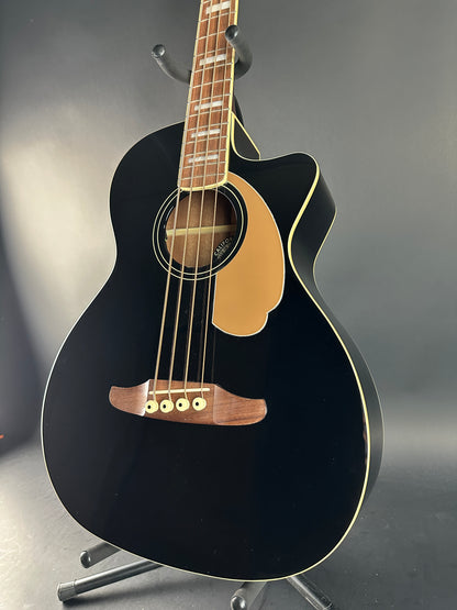 Black acoustic guitar on a gray background