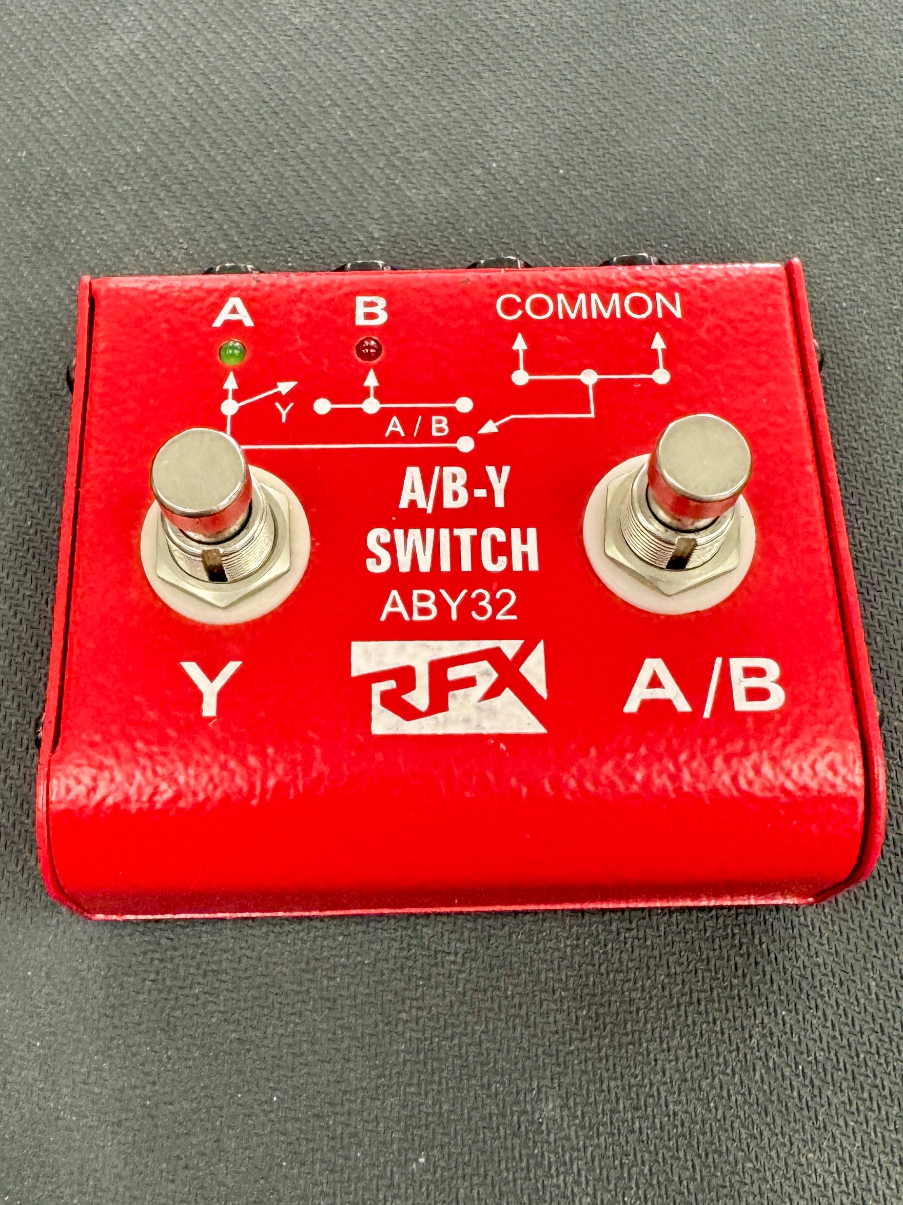 Red A/B-Y switch pedal with two toggle switches on a gray background