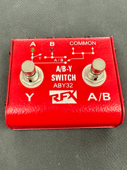 Red A/B-Y switch pedal with two toggle switches on a gray background