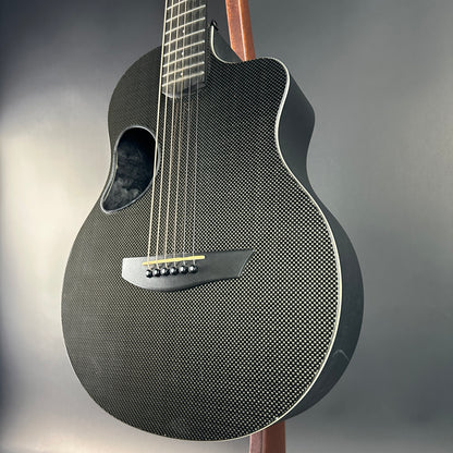 Carbon fiber acoustic guitar on a gray background