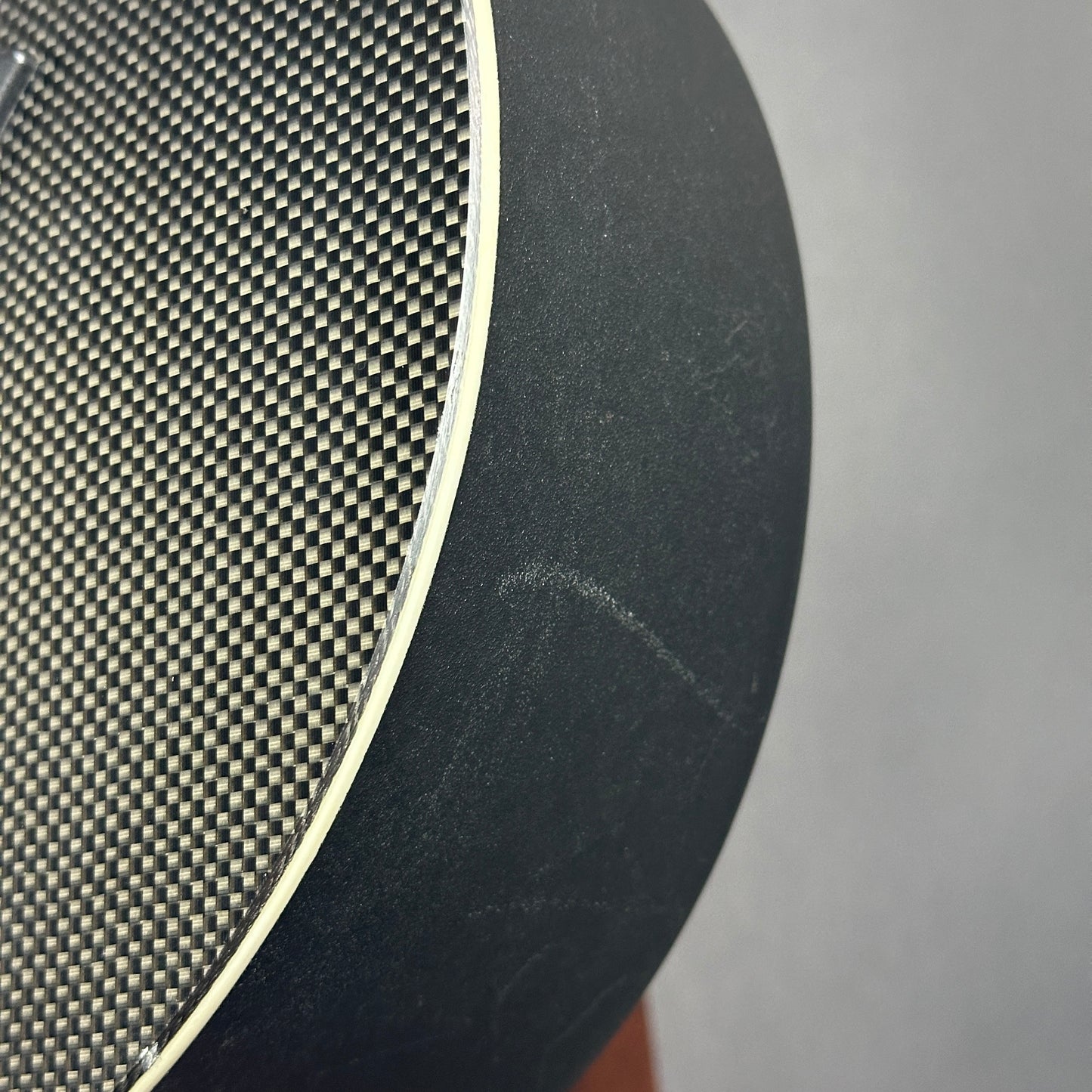 Scratch on side of Used Kevin Michael Touring Carbon Fiber Acoustic.