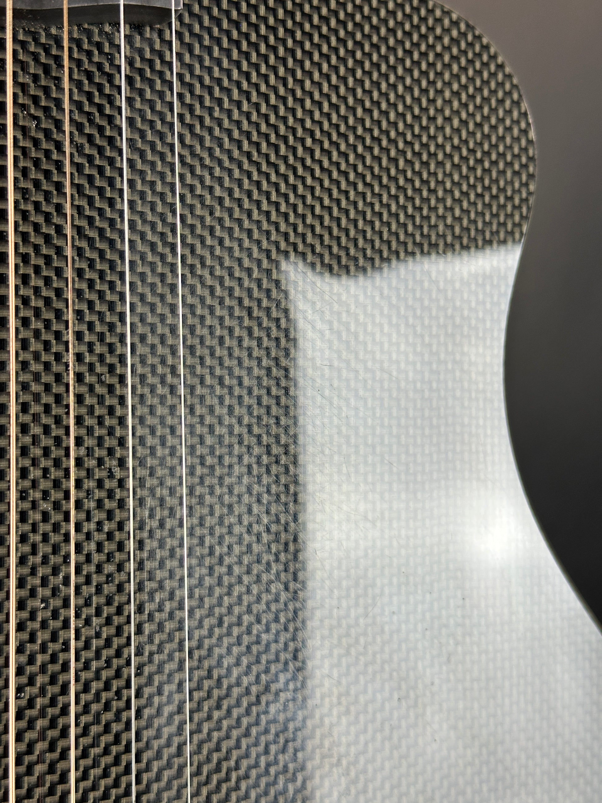 Close-up of a guitar with carbon fiber texture on the body