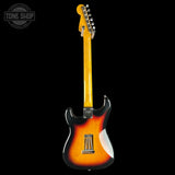 A classic Fender electric guitar shown from the back, featuring a vibrant sunburst finish that transitions from bright yellow-orange to deep black. The glossy yellow headstock and chrome hardware are clearly visible against a solid black background.