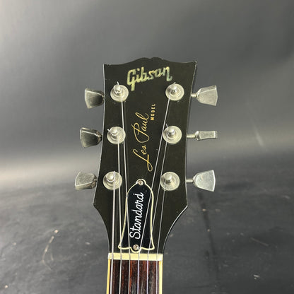 Gibson Les Paul guitar headstock on a dark background