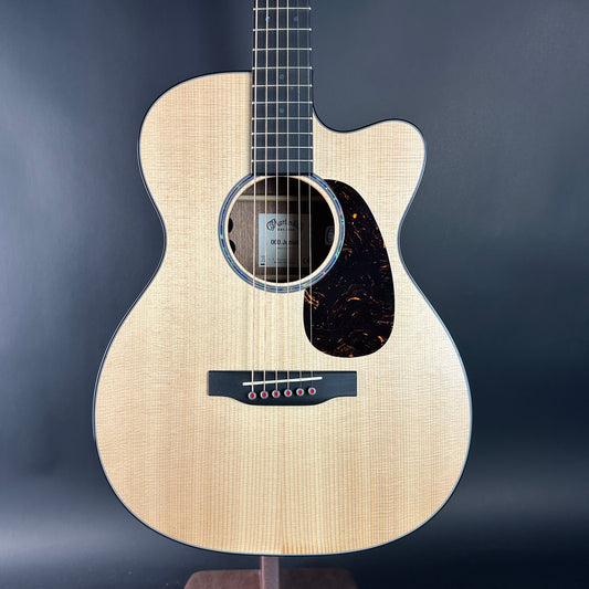 Acoustic guitar with a wooden finish on a dark background