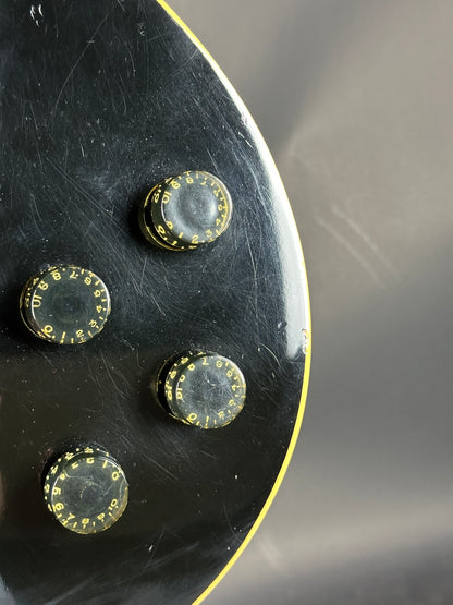 Four metallic buttons with a textured surface on a black background