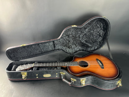 Acoustic guitar in a hard-shell case on a gray background