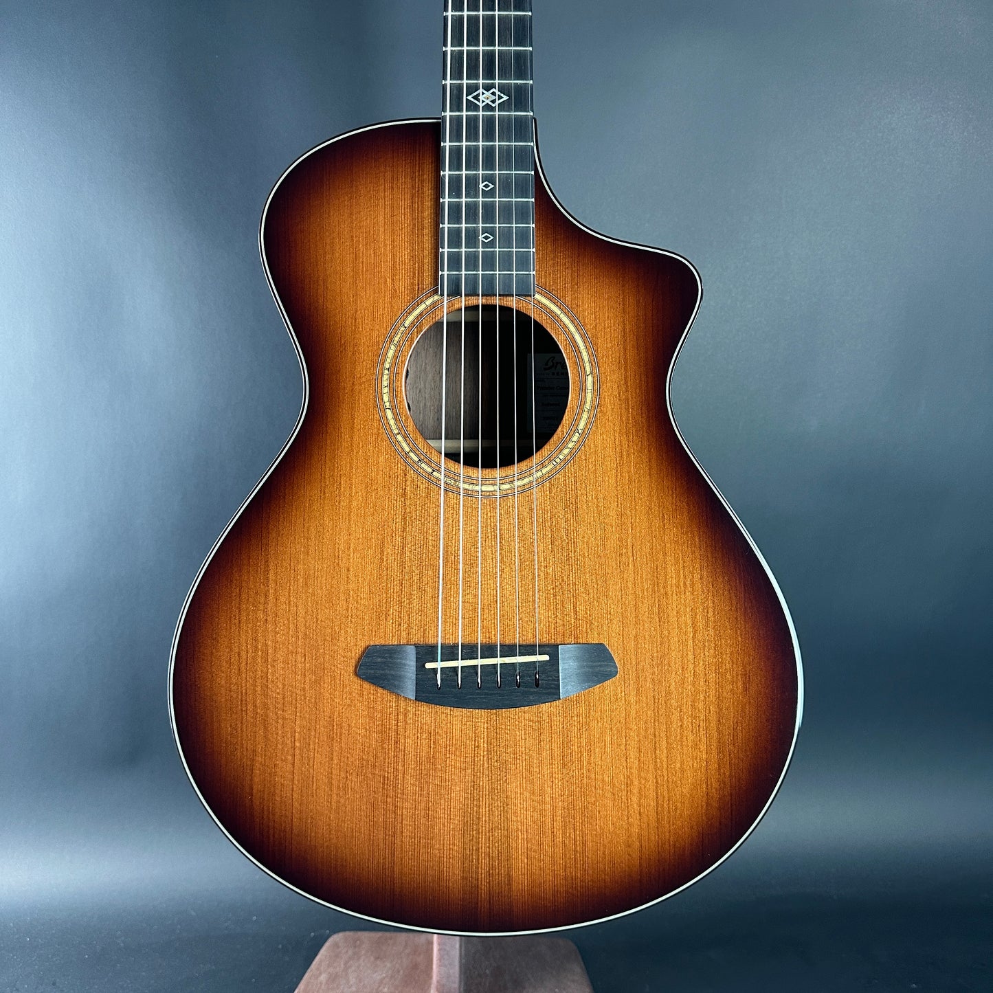 Acoustic guitar with a sunburst finish on a gray background
