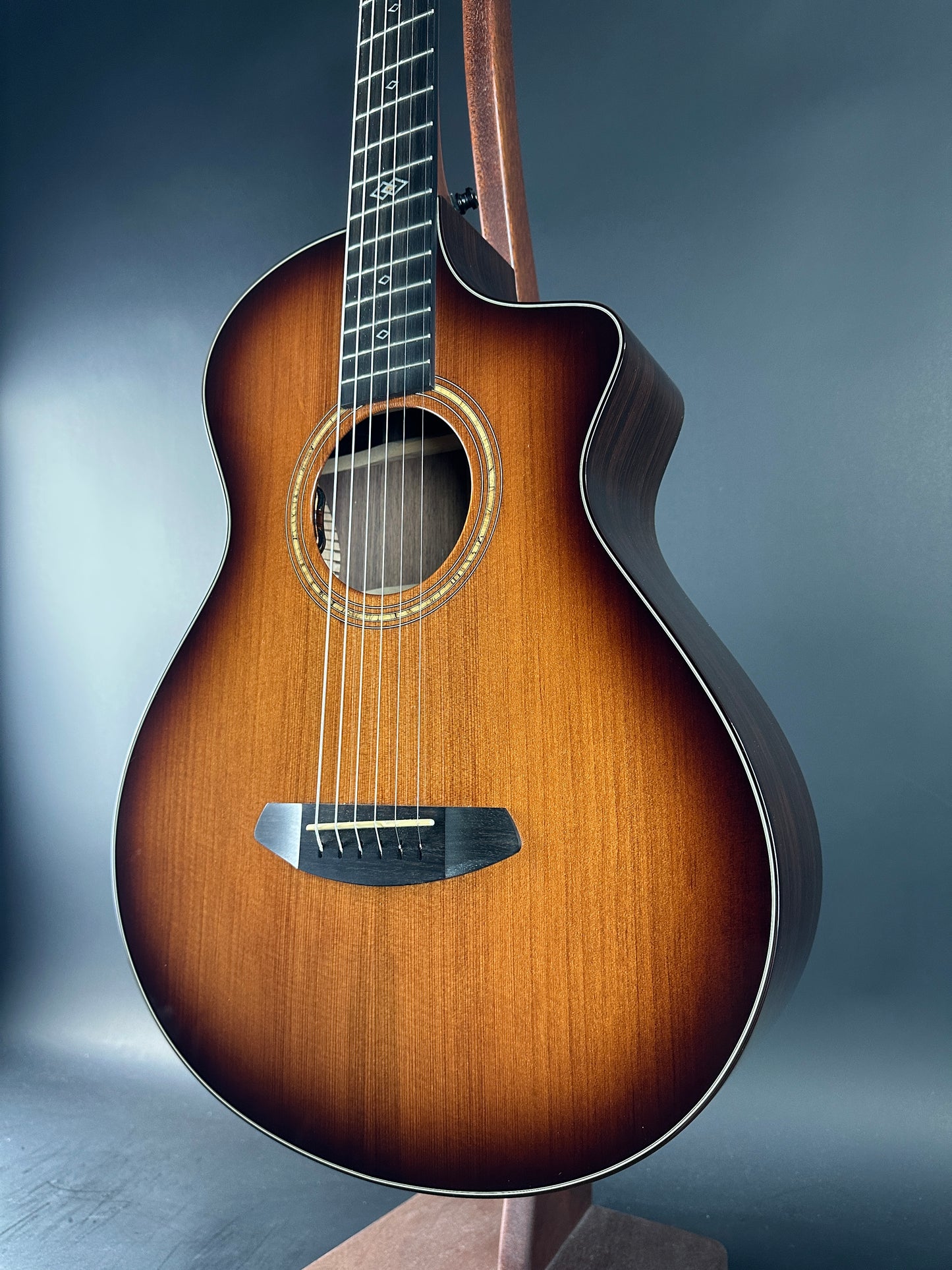Acoustic guitar with a brown finish on a gradient blue background