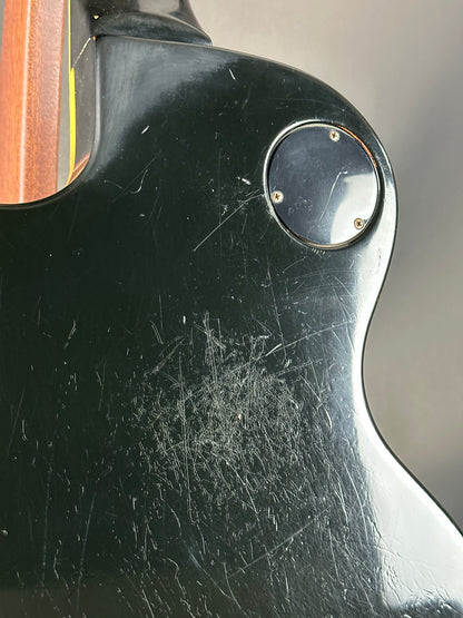 Close-up of a guitar with visible wear and tear on the body