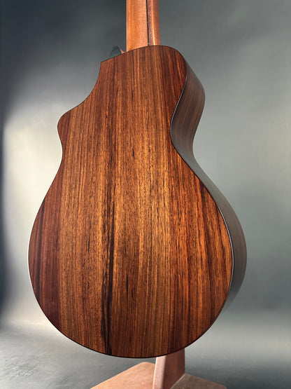 Close-up of a wooden guitar body on a gray background