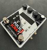 Electro-Harmonix Pitch Fork Plus guitar effects pedal on a dark surface