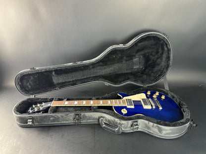 Blue electric guitar in a gray case on a gray background