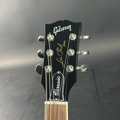 Gibson Les Paul guitar headstock on a gray background