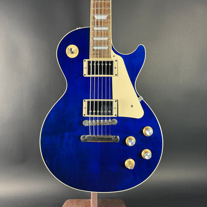 Blue electric guitar on a gray background