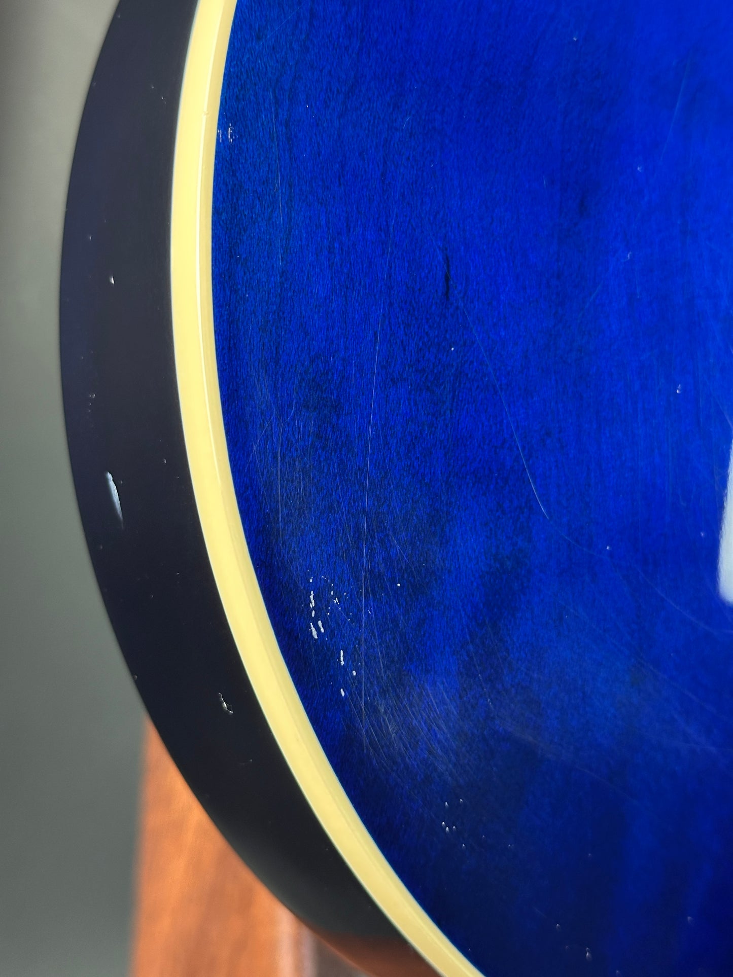 Close-up of a blue surface with a gold rim, possibly a table or a decorative item.